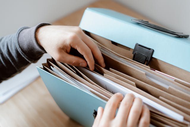 Person organizing documents in a binder